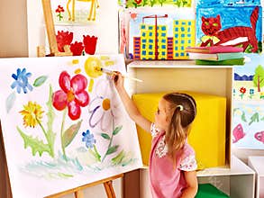 Child painting at easel.