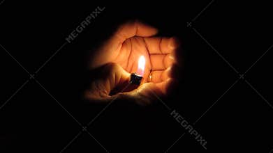 Holding a lighter in the darkness