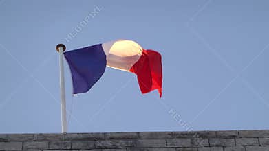 The flag of France waving on top of a bu