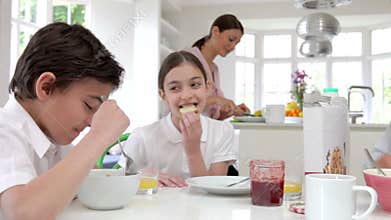 Family Having Breakfast Before Husband Goes To Work