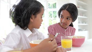 Children Having Breakfast In Kitchen Before School