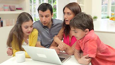 Hispanic Family Using Laptop At Home