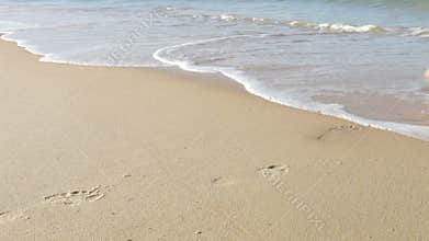 Close Up Of Man Walking Along Beach And Into Sea