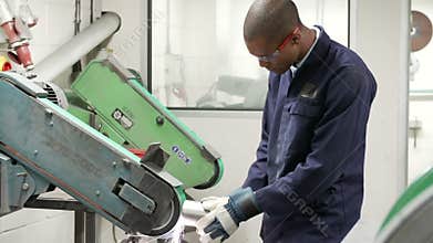 Engineer Using Grinding Machine In Factory