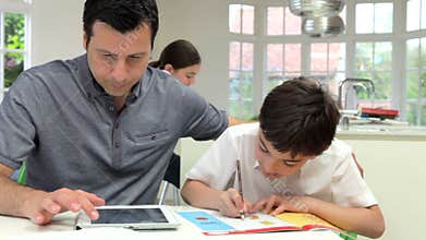 Father Helping Children With Homework