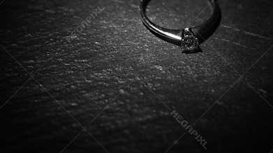 A ray of light falls on a ring with a precious stone.