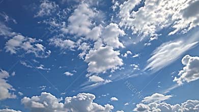 Fragmented clouds, remnants of a passing storm, scatter across the sky, leaving patches of brilliant blue Generative AI