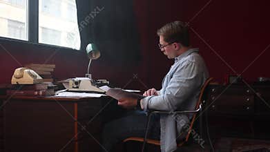 Young author thinking intensely in vintage office,