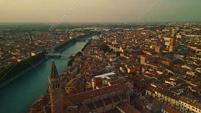 Aerial view of Verona cityscape with Adige river and historic buildings at sunrise