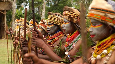 Indigenous women in native costumes dancing in line. Papua New Guinea