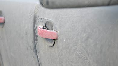 Car door handle covered in dust after long park
