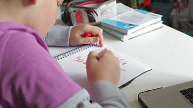 Boy Doing Math's Homework In Bedroom