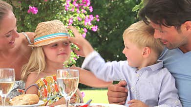 Family Enjoying Outdoor Meal Together
