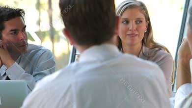 Group Of Businesspeople With Laptop Having Meeting