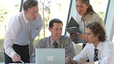 Group Of Businesspeople With Laptop Having Meeting