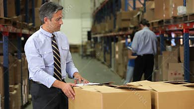 Businessman Checking Box Detail With Clipboard
