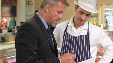 Bank Manager Meeting With Owner Of Butchers Shop