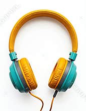 Stylish headphones on white background. Turquoise, yellow earphones. Audio, music listening tech device. Modern lifestyle