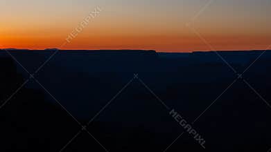 Evening light fades across the deserts and canyons warm colors fill the summer sky