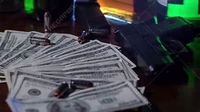 Bullets fall onto pile of money in slow motion