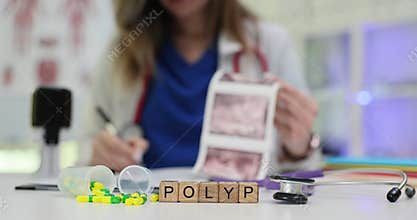 Word Polyp on cubes and pills against doctor with patient scans