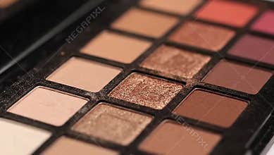 Eyeshadow palette close up: neutral makeup shades for beauty looks and cosmetic application guide
