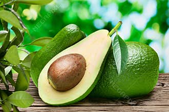 Avocado fruits on the old wooden table.