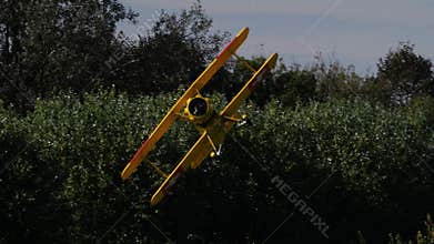 Bucker Bu 133 Jungmeister RC model in a low altitude banking turn