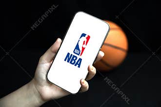 4.1.2025, United States. National Basketball Association logo showing on a mobile screen with ball in the backdrop, illustrative