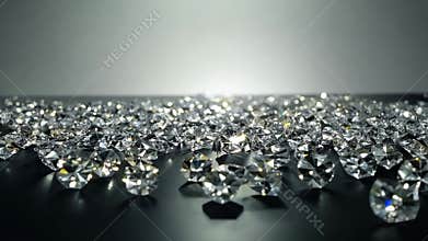 A collection of brilliant-cut diamonds scattered across a reflective black surface, sparkling under soft, diffused lighting
