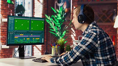 Videographer professionally adjusting clips using mockup PC monitor