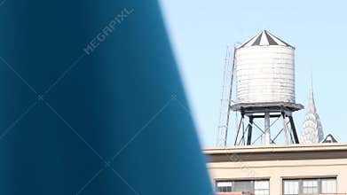 New York City industrial building exterior architecture, USA. Red brick facade. Rooftop water tower.