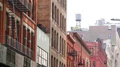 New York City Manhattan architecture, USA. Residential house exterior. Red brick facade, water tower
