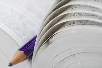 Open book with pencil