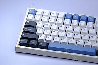 Partial view of a white keyboard with blue and dark keycaps.
