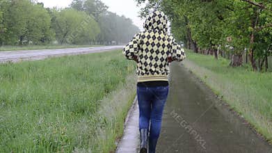 Girl rain walk road