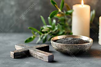 Religion, faith, liturgy, Ash Wednesday, Lent background. Burning candle, brown wooden cross, silver ceremonial ash bowl