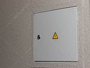 Close up shot of the door to the electric switchboard in the wall of the apartment. Indoors