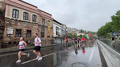Athletes running Istanbul half marathon in historic street of Fener district