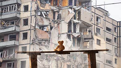 A teddy bear sits on a bench against the backdrop of a house blown up by a Russian missile in the city of Dnepr in Ukraine, War in