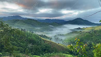 Enchanted Valley with Mist and Mountains at Dawn