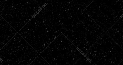 Heavy snow falling on dark background.
