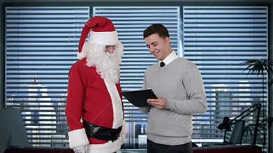 Santa Claus and Young Businessman in a modern office, stock footage