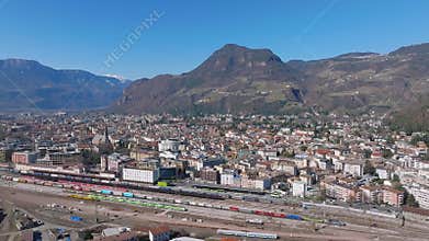 Aerial View of Bolzano, Italy with Trains and Mountain Backdrop