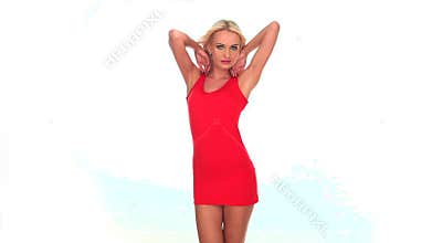 Attractive young woman wearing red dress dancing