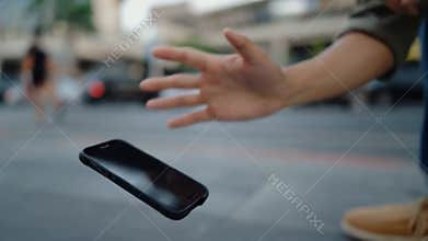 Hand fumbling dropping smartphone sidewalk accident broken screen risk concept stock footage Generative AI