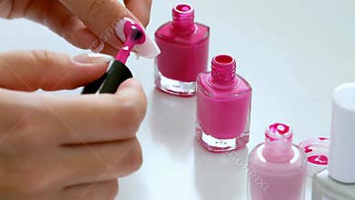 Hand applying pink nail polish bottle brush manicure beauty care cosmetics stock footage Generative AI