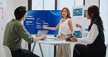 Group of Asian generation z business people work together in home office. Financial team businesspeople brainstorm meeting