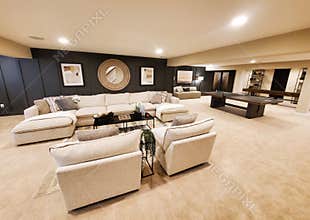 A spacious basement room, featuring a bright and comfortable sectional sofa and accent