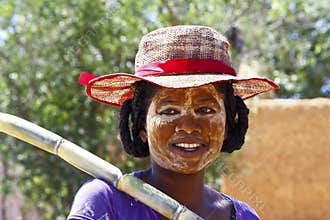 Portrait of malagasy woman with tradytional mask on the face